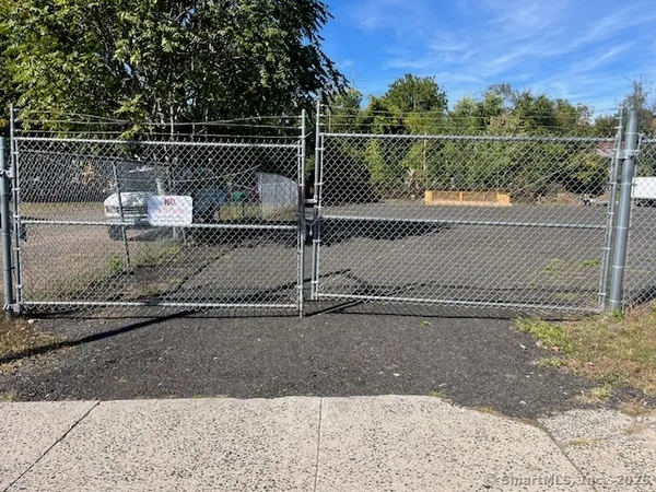 a view of a field with trees in the background