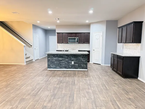 a spacious bathroom with a sink and a mirror