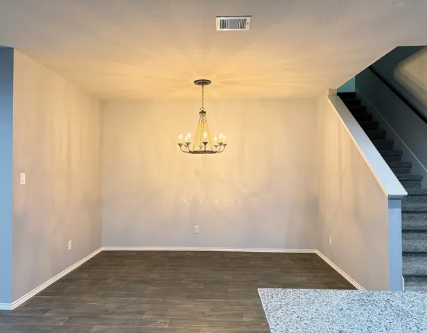 a view of a livingroom with wooden floor and a ceiling fan