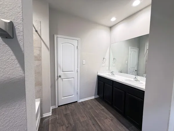 a bathroom with a double vanity sink and mirror
