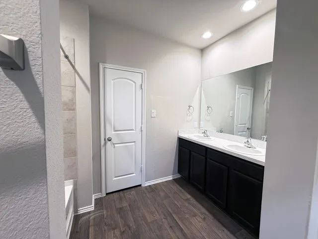 a bathroom with a double vanity sink and mirror