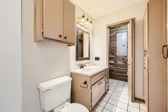 a bathroom with a toilet sink and mirror