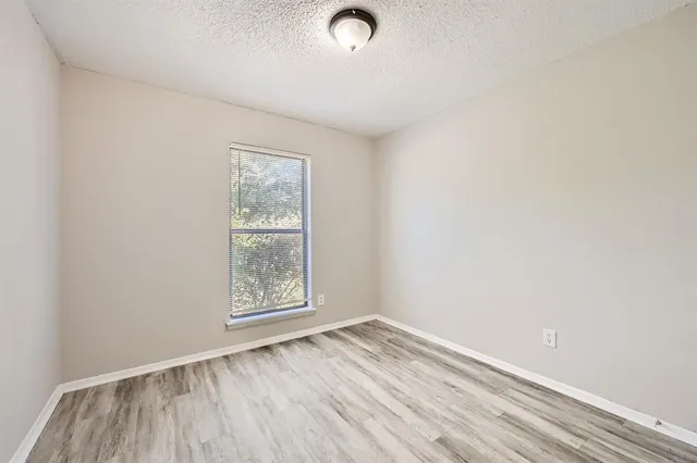 a view of a room with wooden floor and white doors