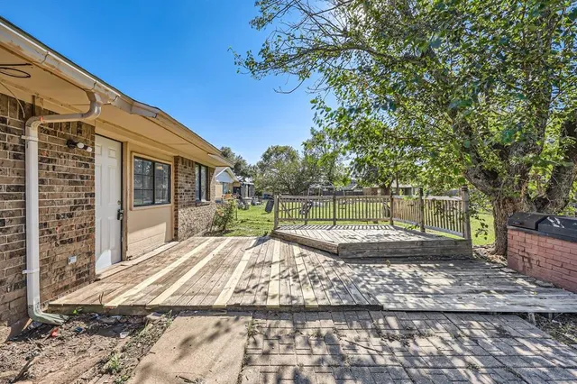 a view of a backyard with large trees