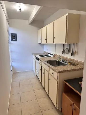a kitchen with a sink stove and cabinets