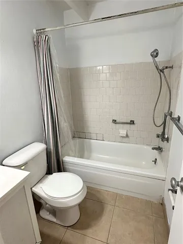 a bathroom with a toilet and a bathtub