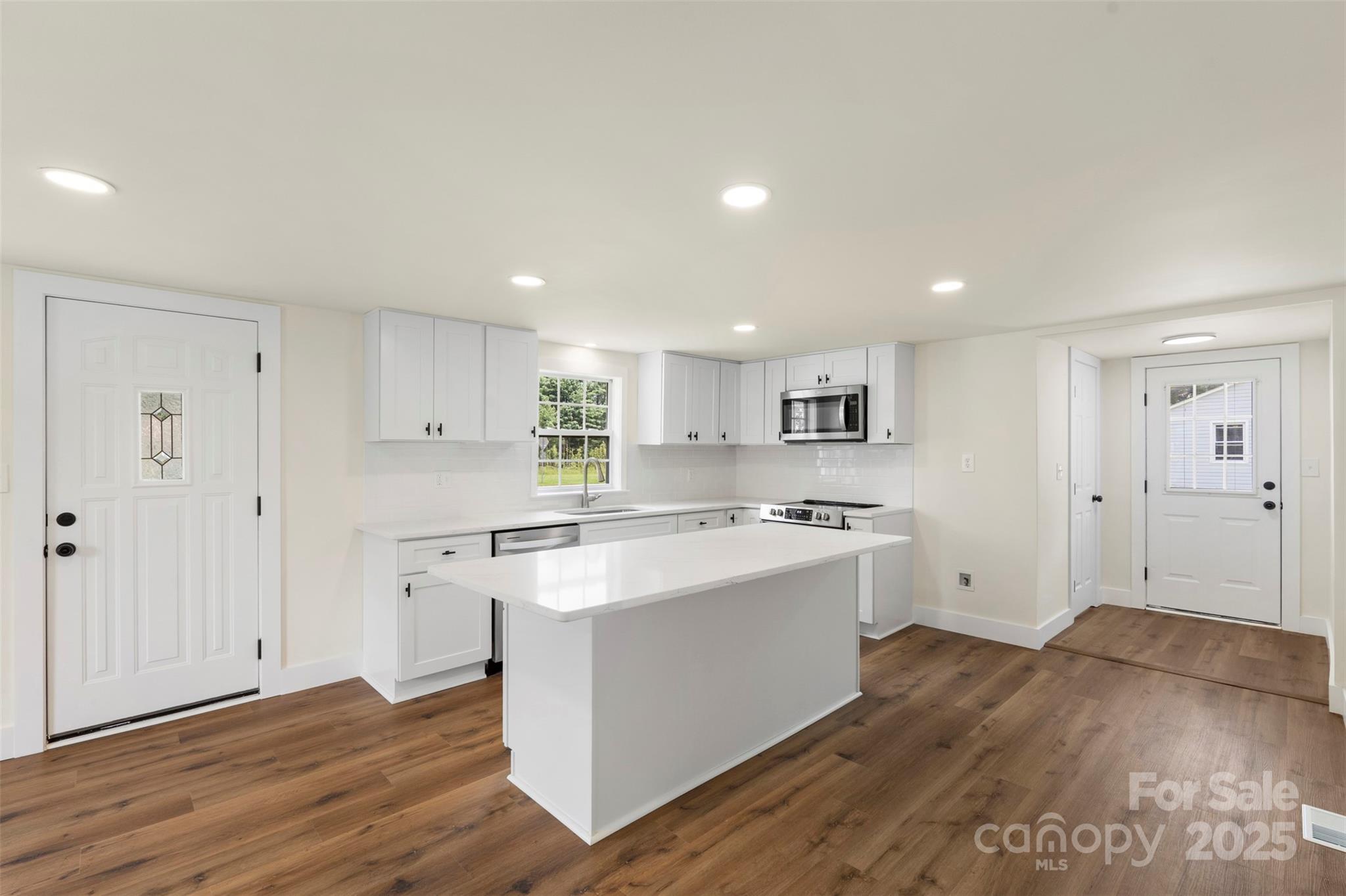 3114 Taxahaw Road Lancaster, SC 29720 - Photo 8 of 41 a kitchen with stainless steel appliances granite countertop a stove and a refrigerator
