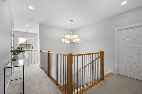 a view of a hallway to dining room with wooden floor