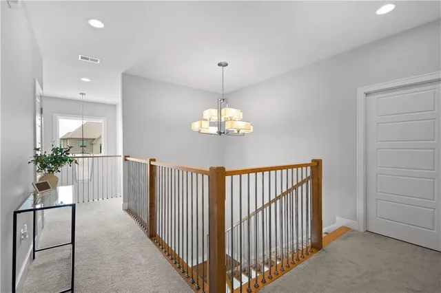 a view of a hallway to dining room with wooden floor