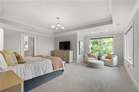 a spacious bedroom with a bed and a couch