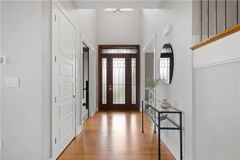 a view of a hallway with wooden floor and staircase