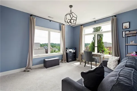 a living room with furniture a bed and a chandelier
