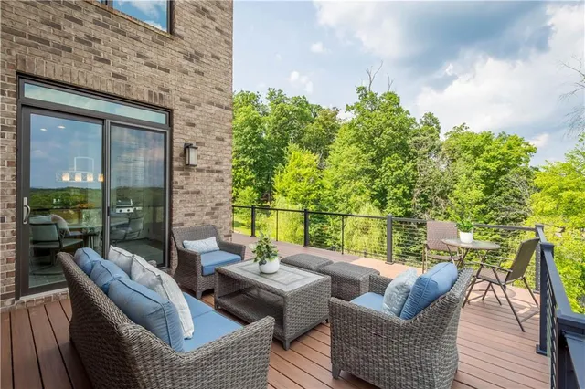 a balcony with furniture and a potted plant