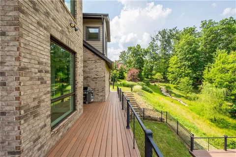 a view of a balcony with wooden floor and fence