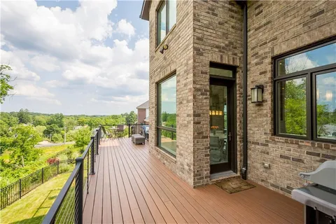 a view of a balcony with wooden floor and iron stairs