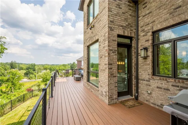 a view of a balcony with wooden floor and iron stairs