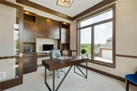 a kitchen with a table chairs and flat screen tv