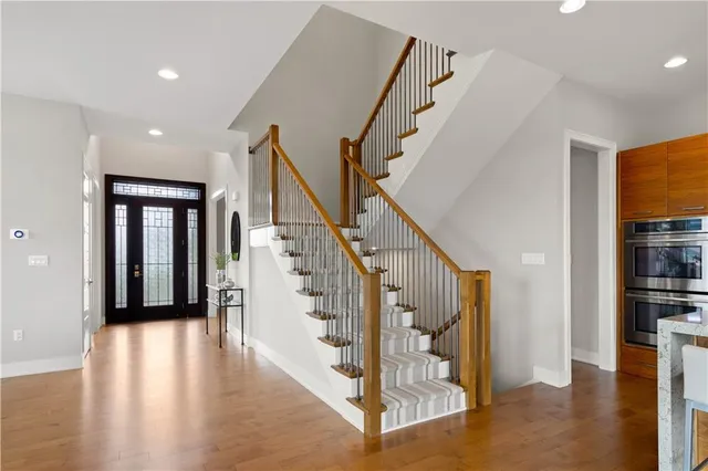 a view of entryway and hall with wooden floor