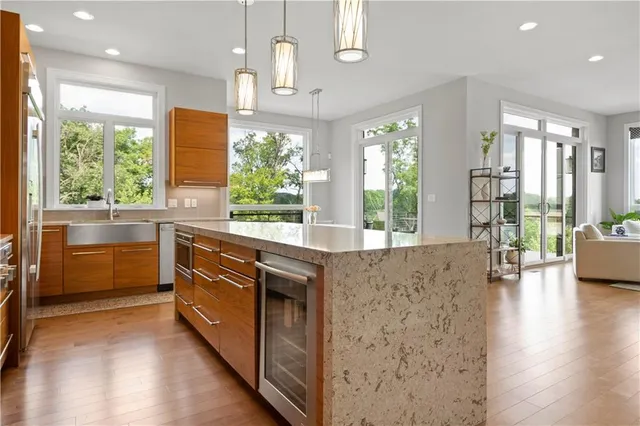 a kitchen with stainless steel appliances granite countertop a stove a sink and a refrigerator