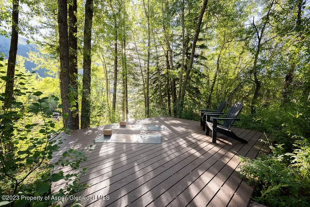 a view of a patio with chairs and a table