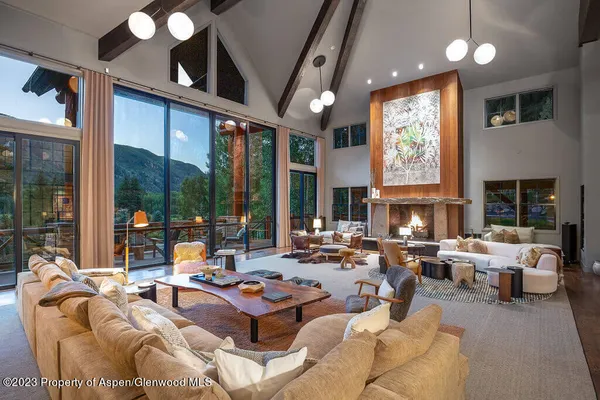 a living room with furniture fireplace and a large window