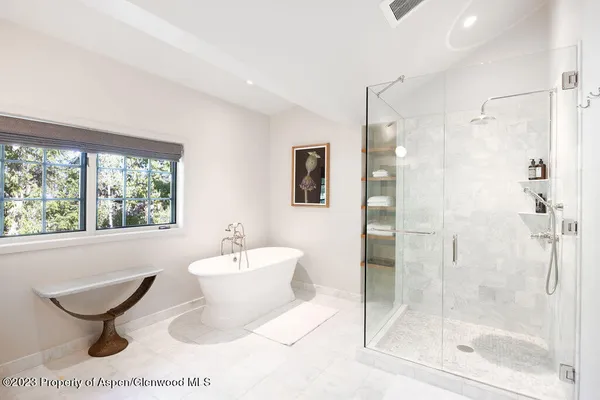 a bedroom with a large bed and a flat screen tv