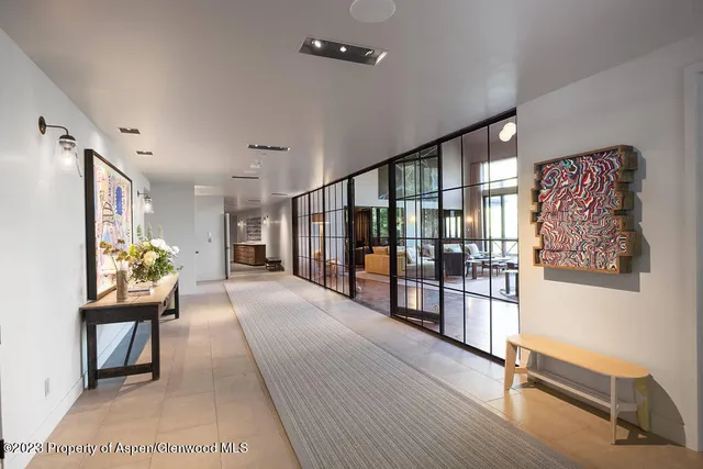 a kitchen with stainless steel appliances granite countertop a stove a sink a dining table and chairs with wooden floor