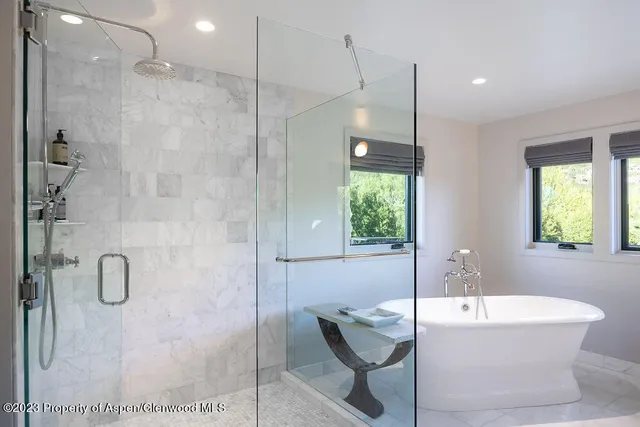 a bedroom with a bed and a lamp on dresser