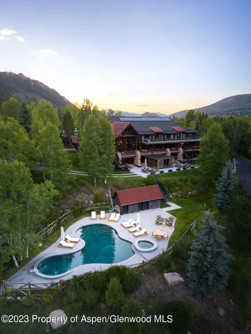 a bathroom with a double vanity sink mirror and shower