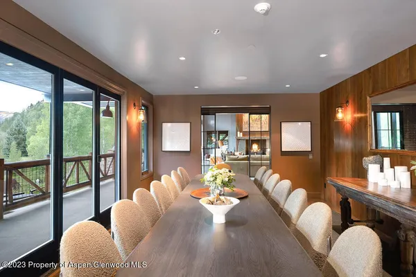 a living room with furniture fireplace and a large window
