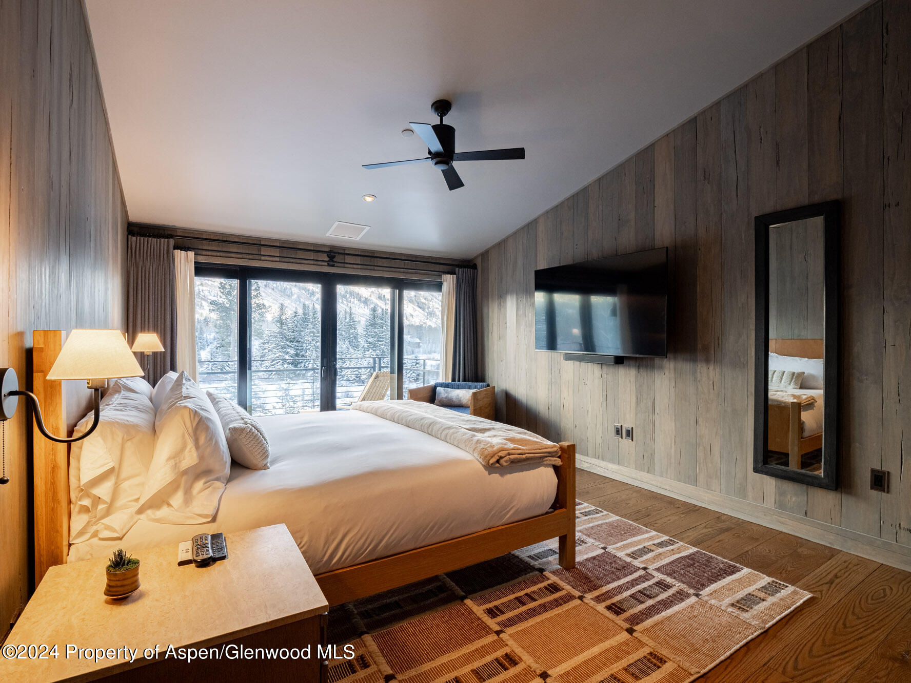 1490 Ute Avenue Aspen, CO 81611 - Photo 58 of 82 a bed sitting in a spacious bedroom next to a window with pc on the floor