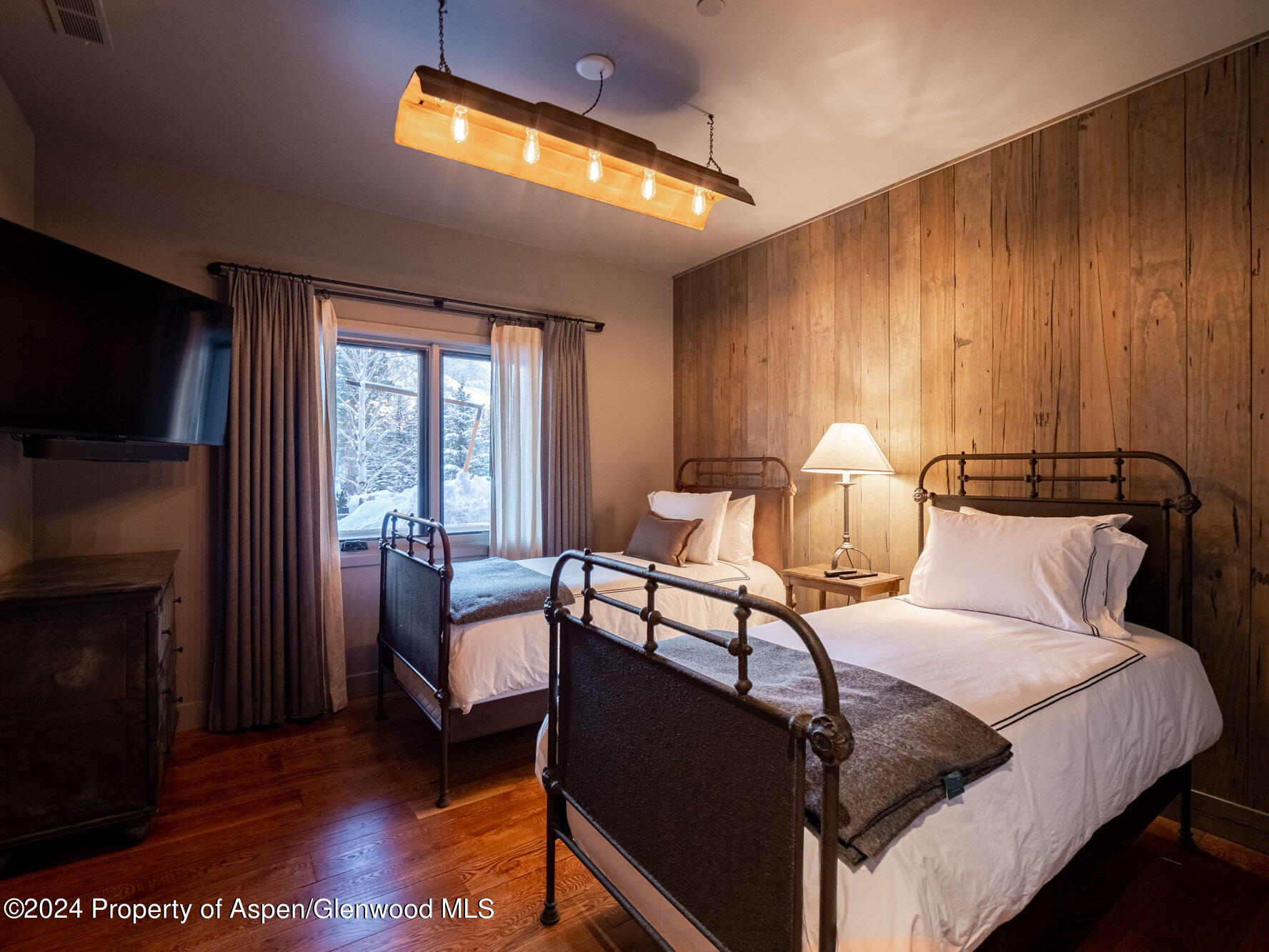1490 Ute Avenue Aspen, CO 81611 - Photo 75 of 82 a bedroom with furniture and a flat screen tv