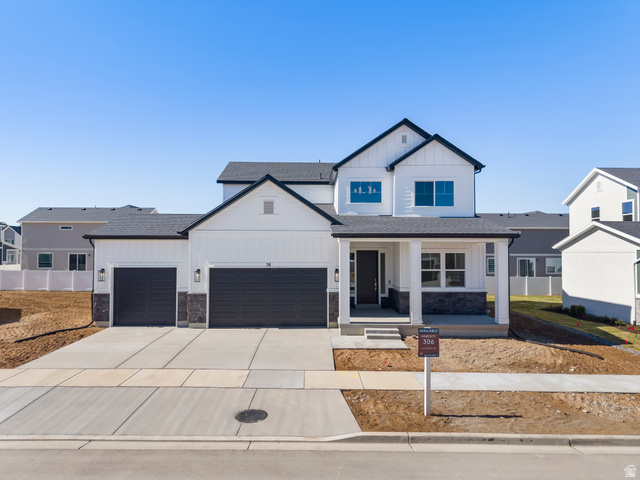58 South Crimson Way, Unit 306 Mapleton, UT 84664 - Photo 1 of 24 Contemporary two-story residence featuring white siding, dark trim, and a covered front porch with stone accents