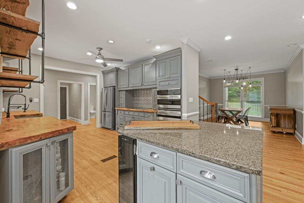 2230 Ewing Chapel Road Dacula, GA 30019 - Photo 15 of 54 a kitchen with stainless steel appliances granite countertop a sink stove and refrigerator