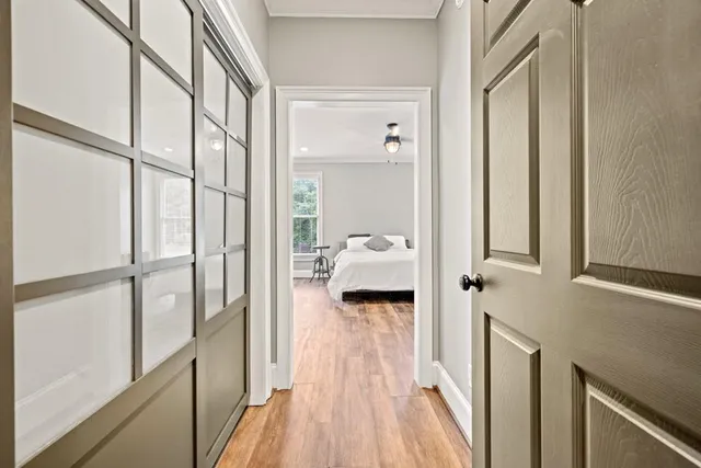 a view of empty room with wooden floor and windows