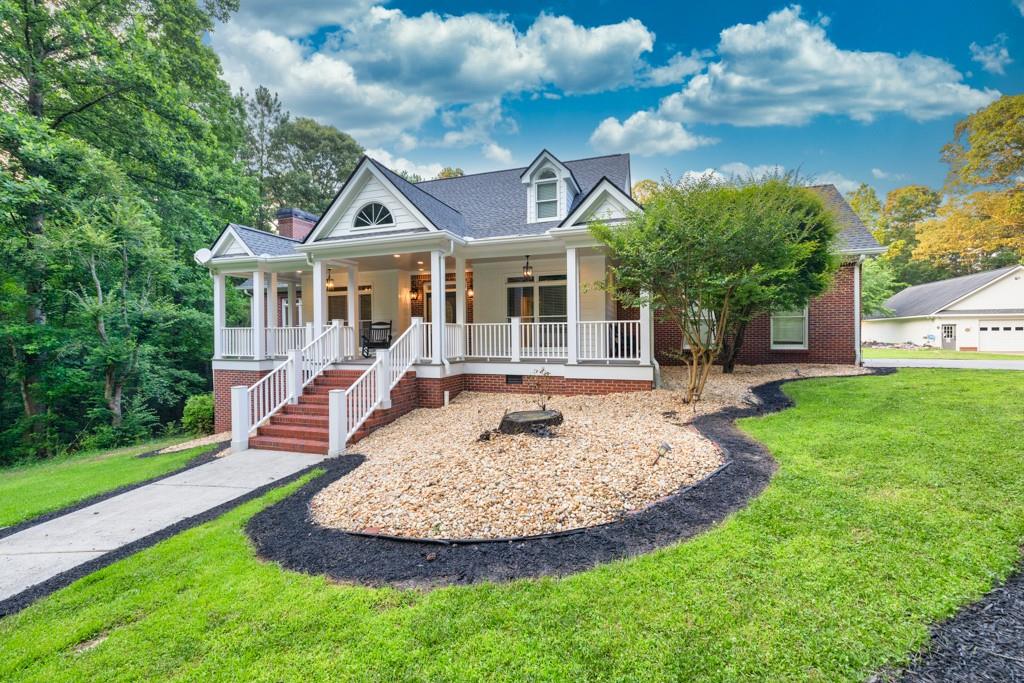 2230 Ewing Chapel Road Dacula, GA 30019 - Photo 2 of 54 a front view of a house with a yard