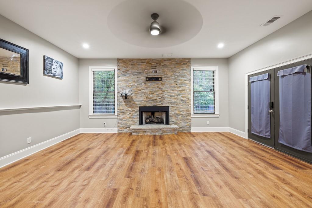 2230 Ewing Chapel Road Dacula, GA 30019 - Photo 25 of 54 an empty room with windows and a fireplace