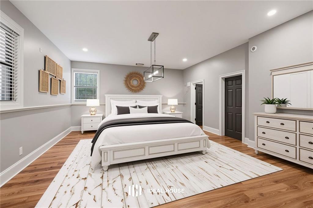 2230 Ewing Chapel Road Dacula, GA 30019 - Photo 32 of 54 a bedroom with a large bed and a dresser