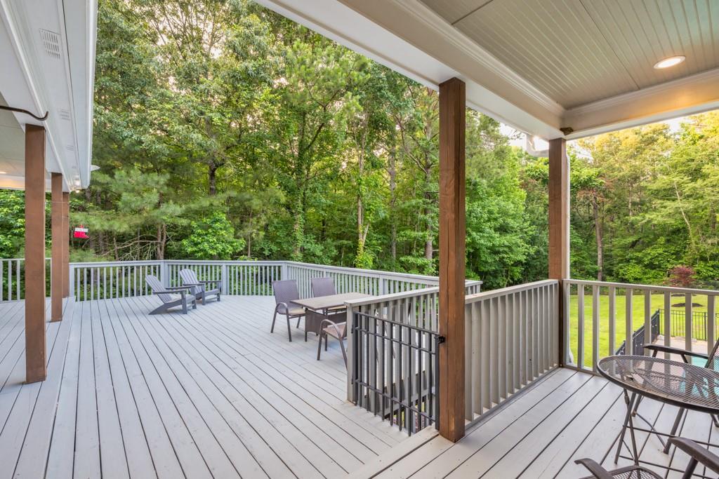 2230 Ewing Chapel Road Dacula, GA 30019 - Photo 41 of 54 a balcony with wooden floor table and chairs