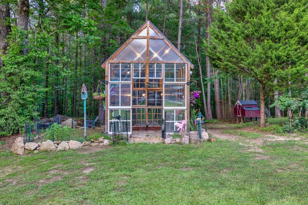 2230 Ewing Chapel Road Dacula, GA 30019 - Photo 42 of 54 a front view of a house with a yard table and chairs