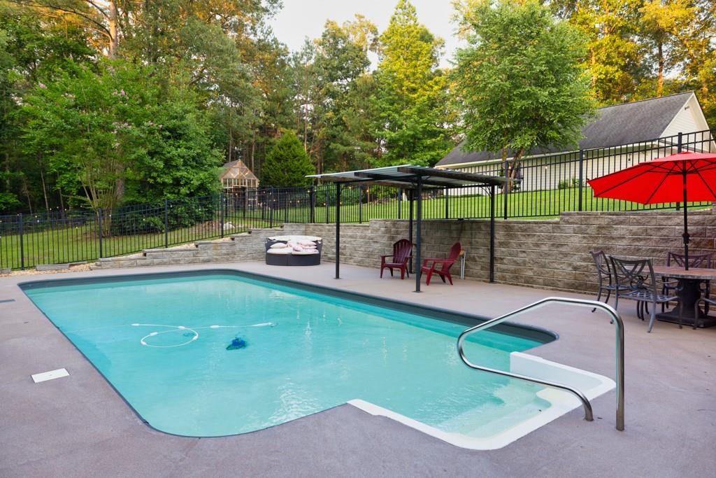 2230 Ewing Chapel Road Dacula, GA 30019 - Photo 47 of 54 an aerial view of a swimming pool with a patio