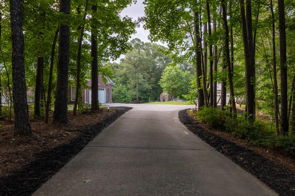 2230 Ewing Chapel Road Dacula, GA 30019 - Photo 7 of 54 a view of a street with large trees