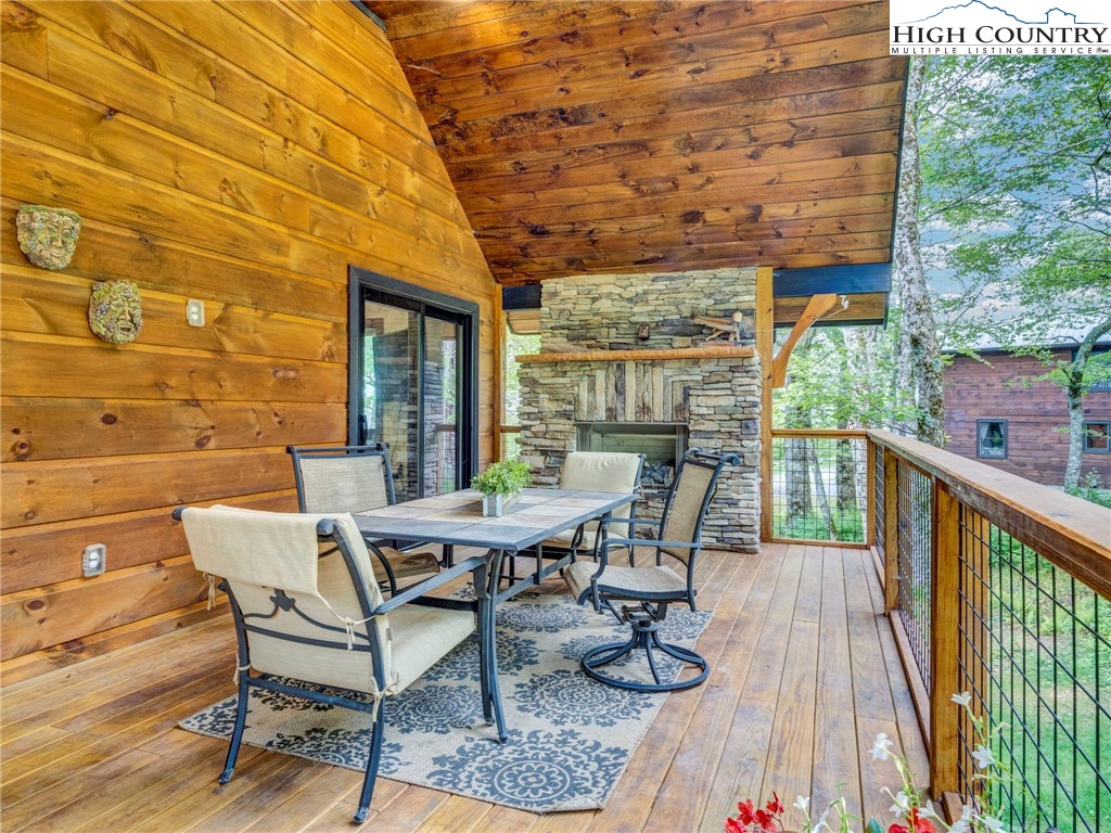 196 Cloud Spring Drive Sugar Mountain, NC 28604 - Photo 12 of 38 a view of a patio with table and chairs and wooden floor