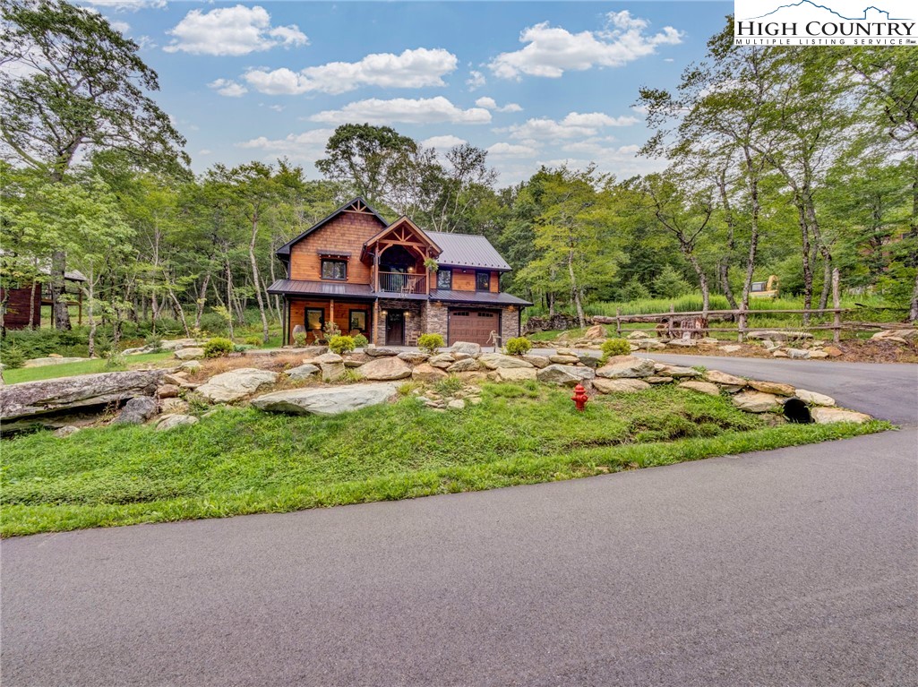 196 Cloud Spring Drive Sugar Mountain, NC 28604 - Photo 38 of 38 a front view of a house with garden and trees
