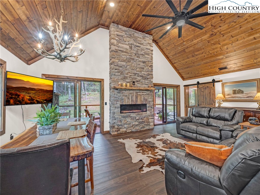 196 Cloud Spring Drive Sugar Mountain, NC 28604 - Photo 8 of 38 a living room with furniture a fireplace and a flat screen tv