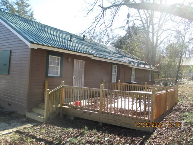 a view of a house with a wooden fence