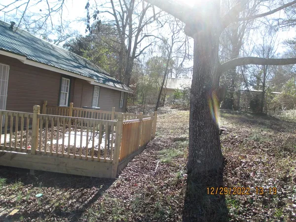 a view of a yard with large trees