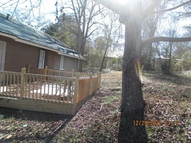 a view of a yard with large trees