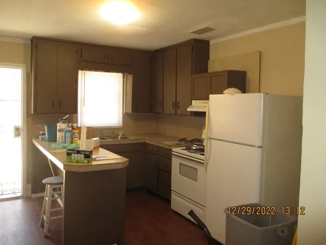a white refrigerator freezer sitting inside of a kitchen
