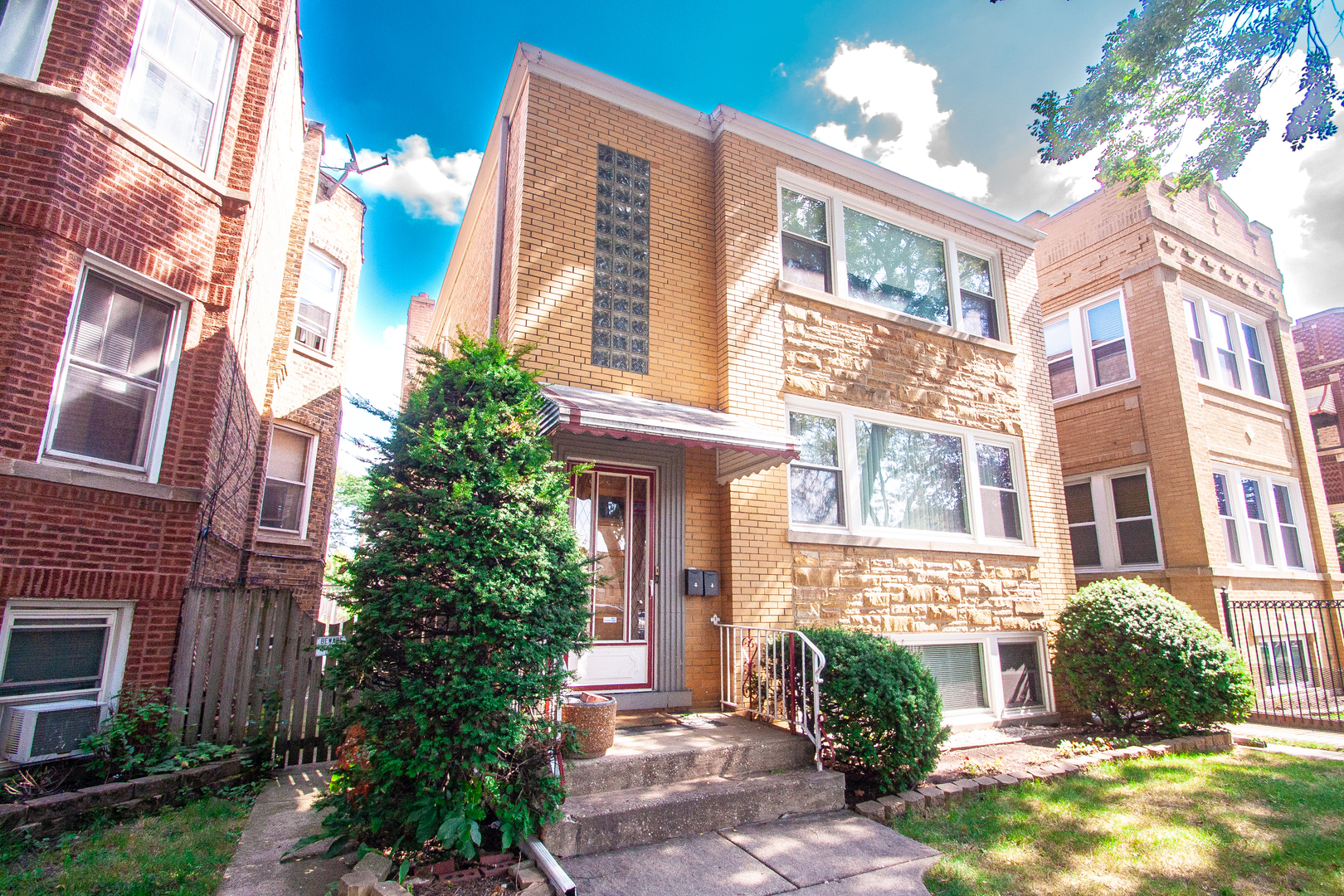 a view of a brick building next to a yard